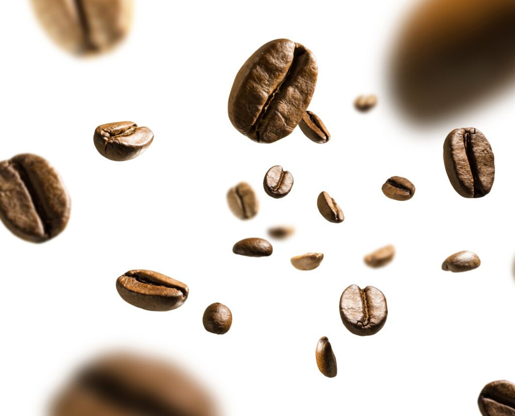 Coffee,Beans,In,Flight,On,White,Background